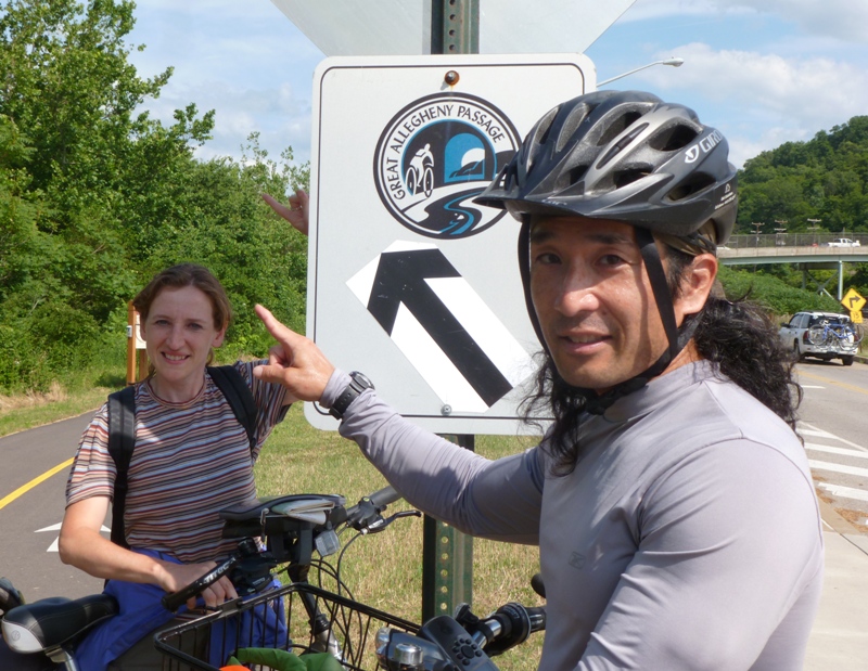 Me pointing in the same direction as the trailhead sign with Norma in the background