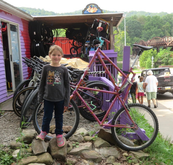 Niece next to tall bike