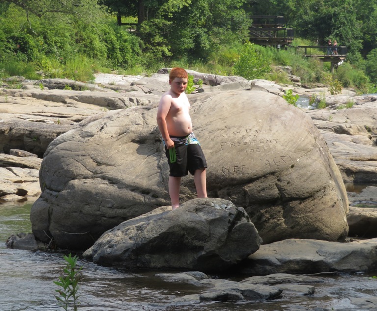 Nephew next to rock carving