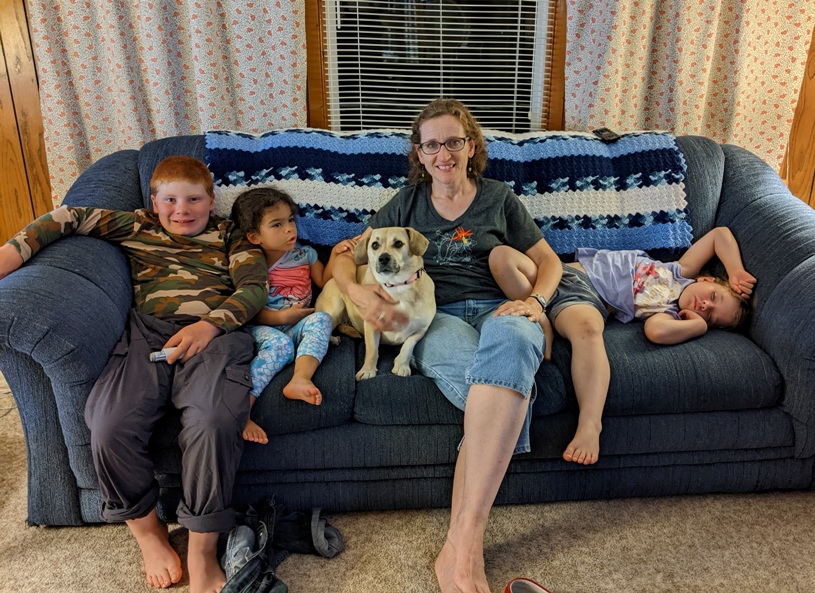 Three kids, Norma, and Daphne on couch