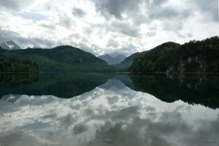 Silhouette of Alpsee against dark skies