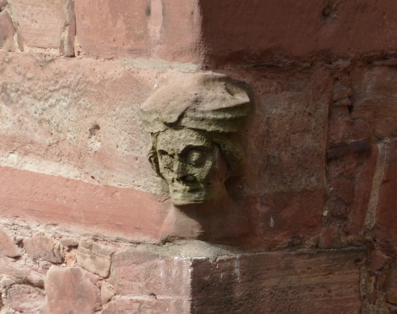 Stone carved face in outer corner of wall