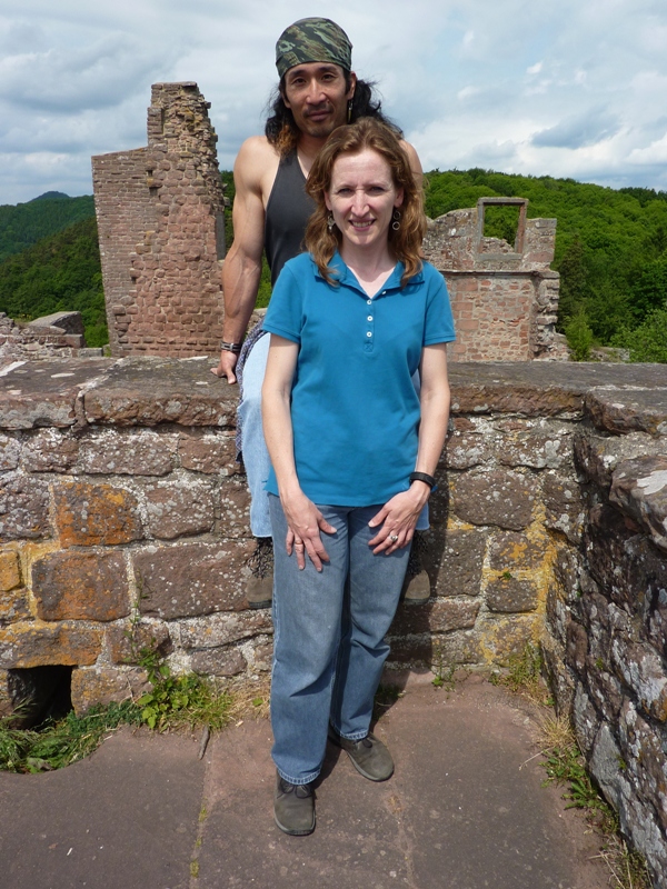 Norma standing and me seated behind her on a stone wall