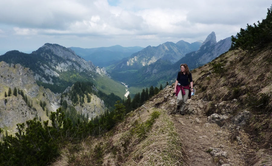 Norma walking on trail on side of mountain