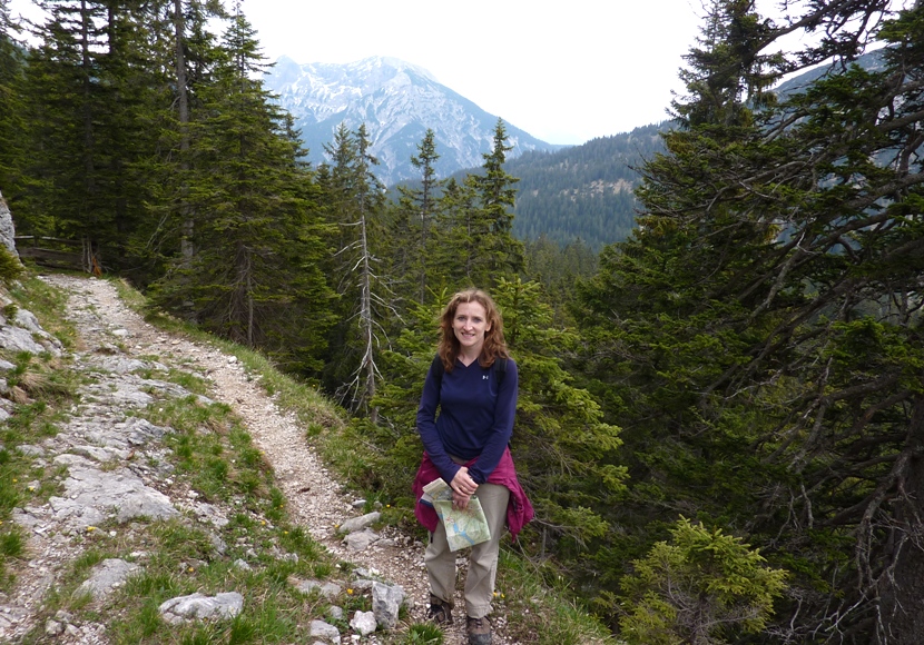 Norma standing on trail holding map