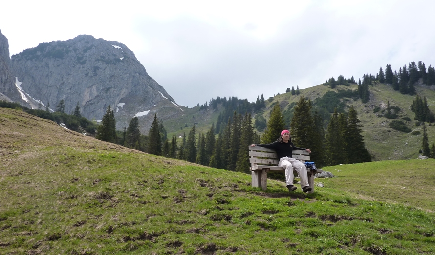 Me seated at bench with mountains behind