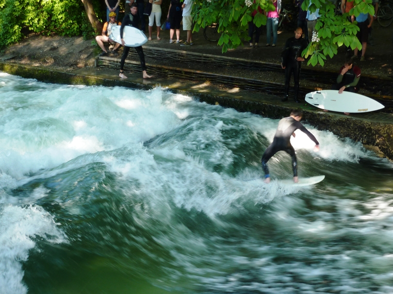 Man surfing on man-made waterway