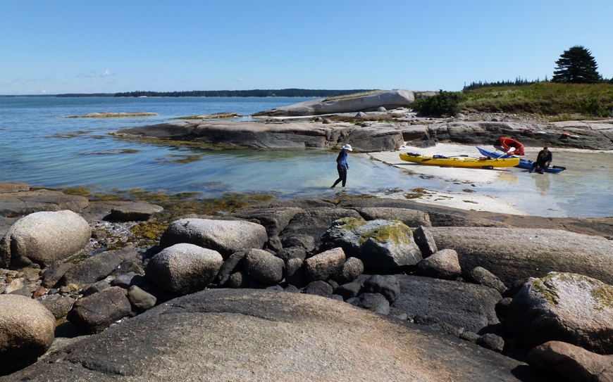 Norma walking on sandy beach on west side of island