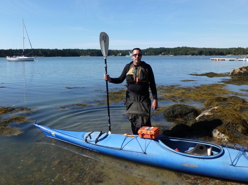 Vince standing by his kayak