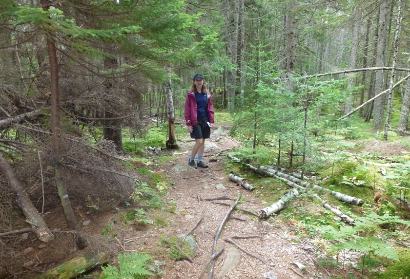 Norma on a trail surrounded by pine and moss