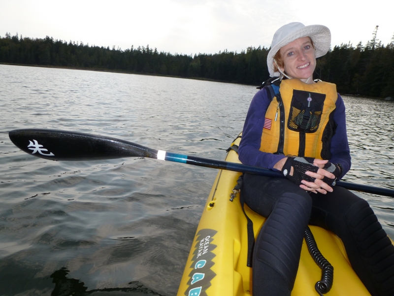 Norma smiling in back of tandem kayak