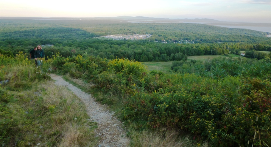 Norma on high part of trail with town in background