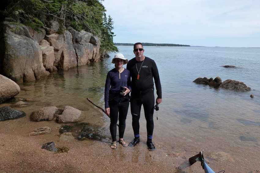 Norma and Vince standing on the shore