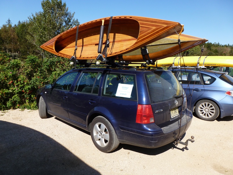 Two wooden boats on top of car