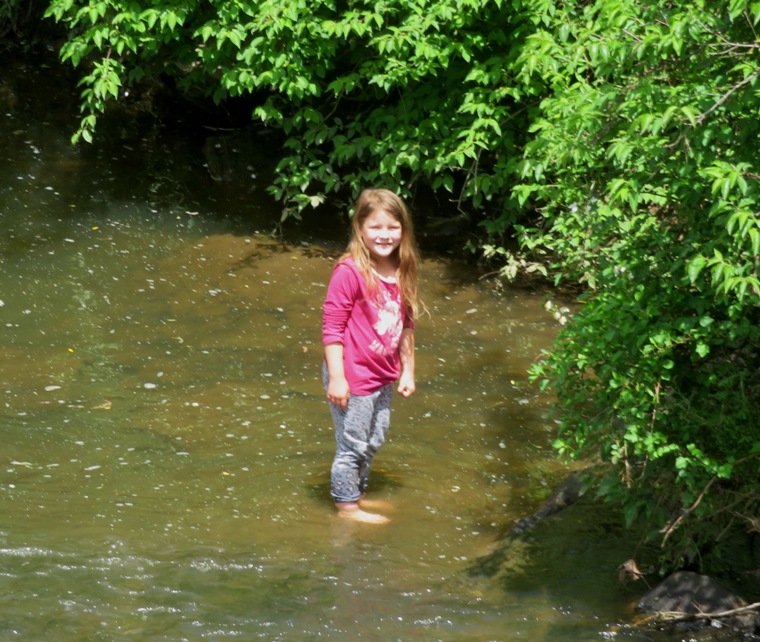 Laah's daughter standing in the river