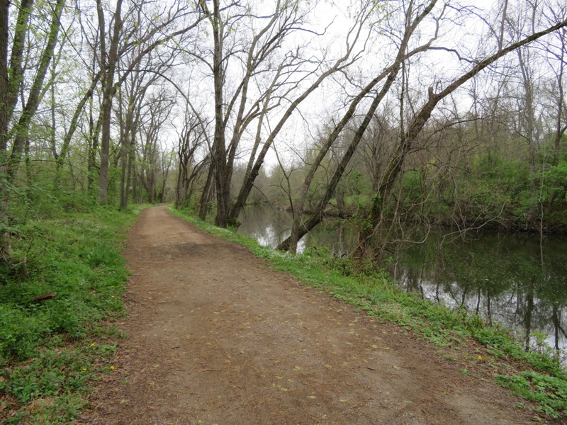 The Delaware and Raritan Trail, a dirt path by the water and trees