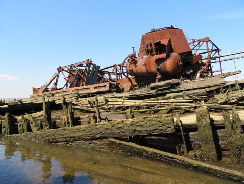 Metal contraption atop wooden debris