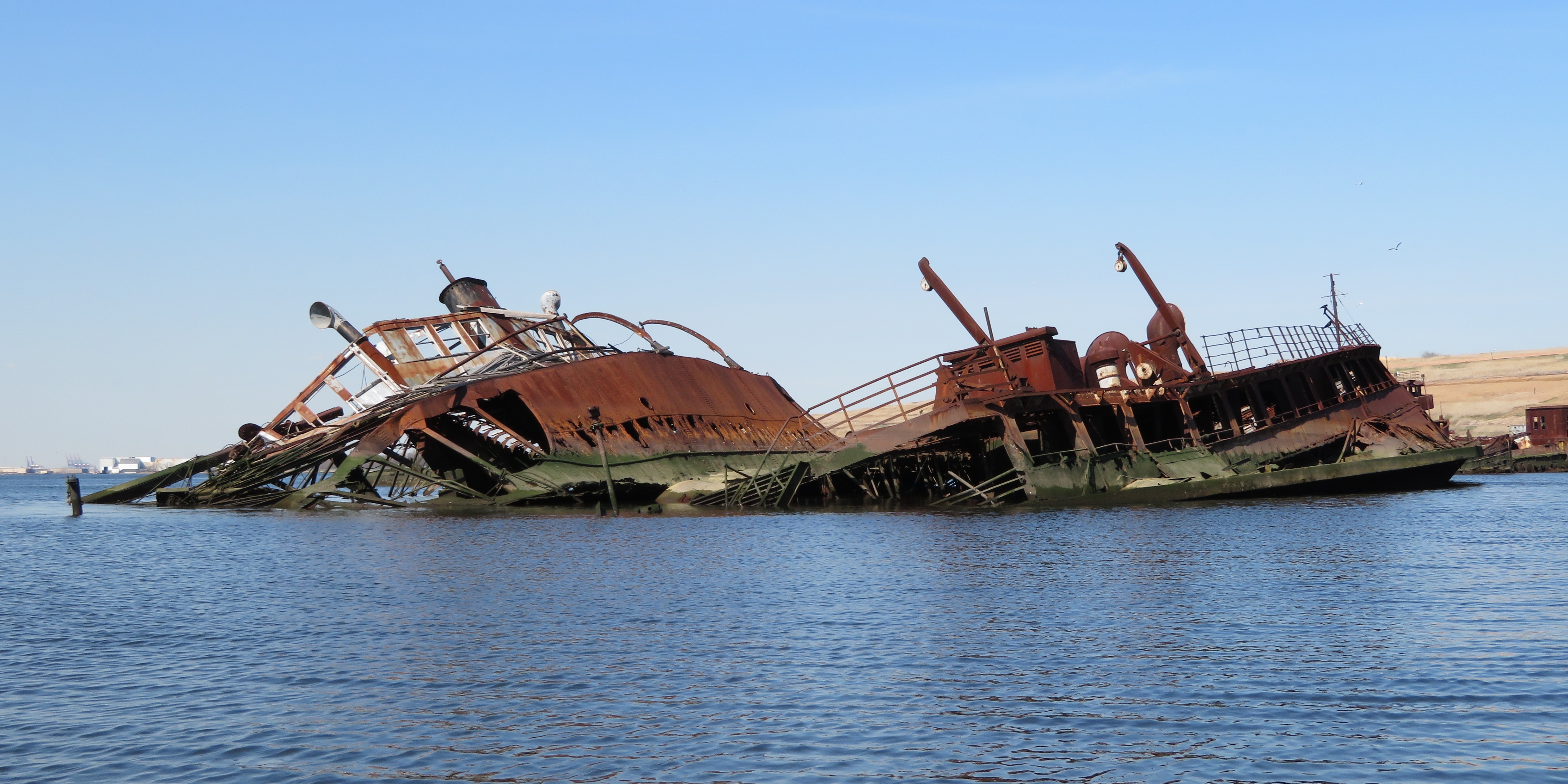 Two shipwrecks protruding above the water