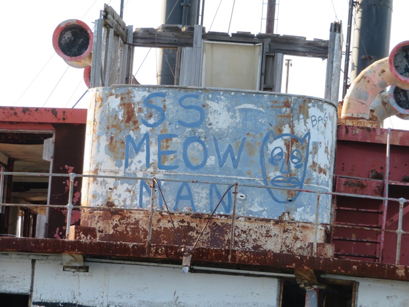 Graffiti designating this red tugboat the 'SS Meow Man'