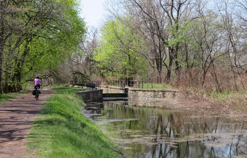 Norma biking by a canal lock