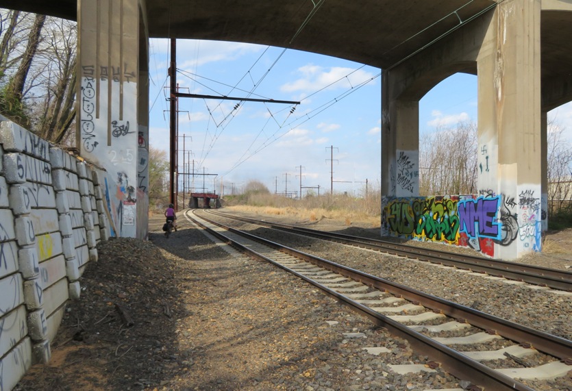 Norma biking along railroad tracks