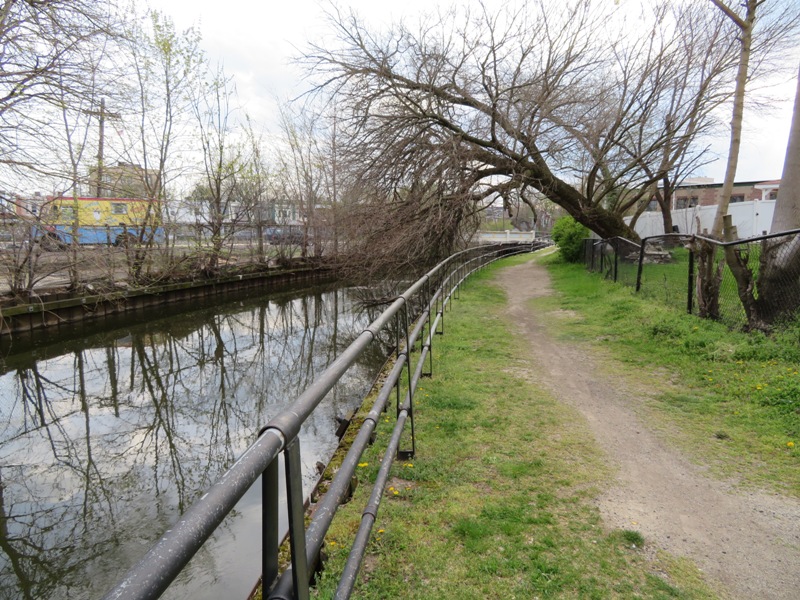 More trees, paved trail, and canal