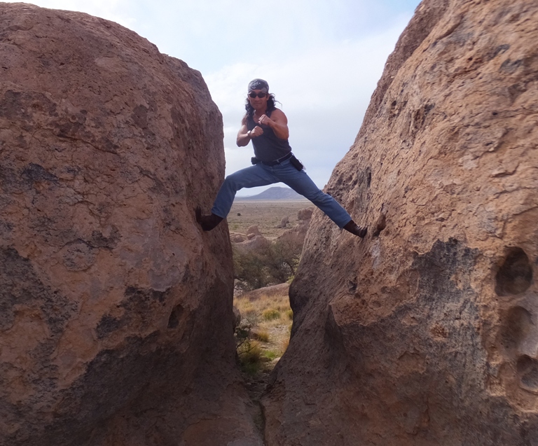 Me in fighting position between two boulders