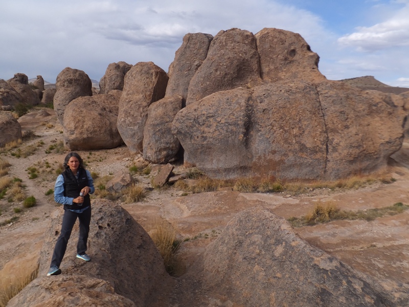 Carmen holding her water bottle among the boulders