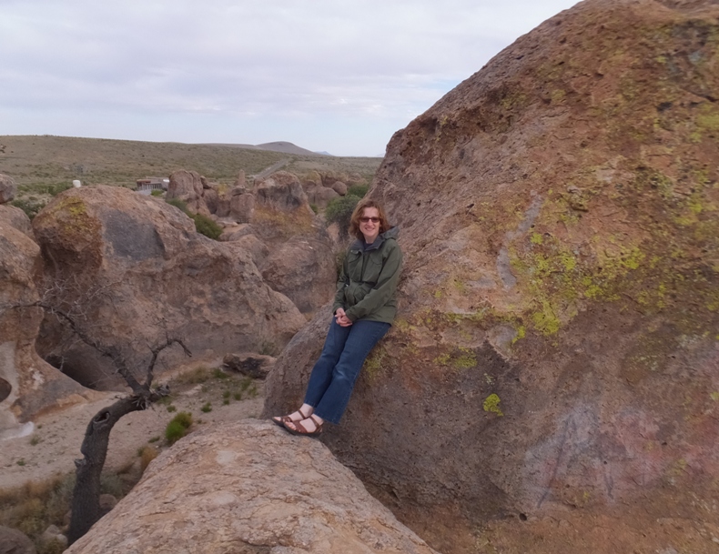 Norma leaning against a huge boulder