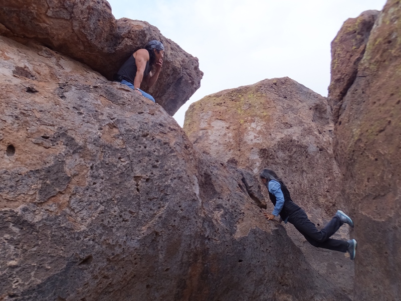 Carmen inching her way up between two rocks while I watch