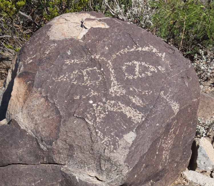 Petroglyph of face on rock