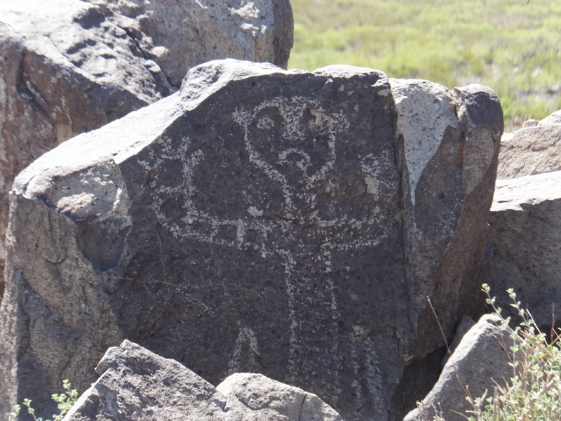 Petroglyph of man showing hands as if surrendering