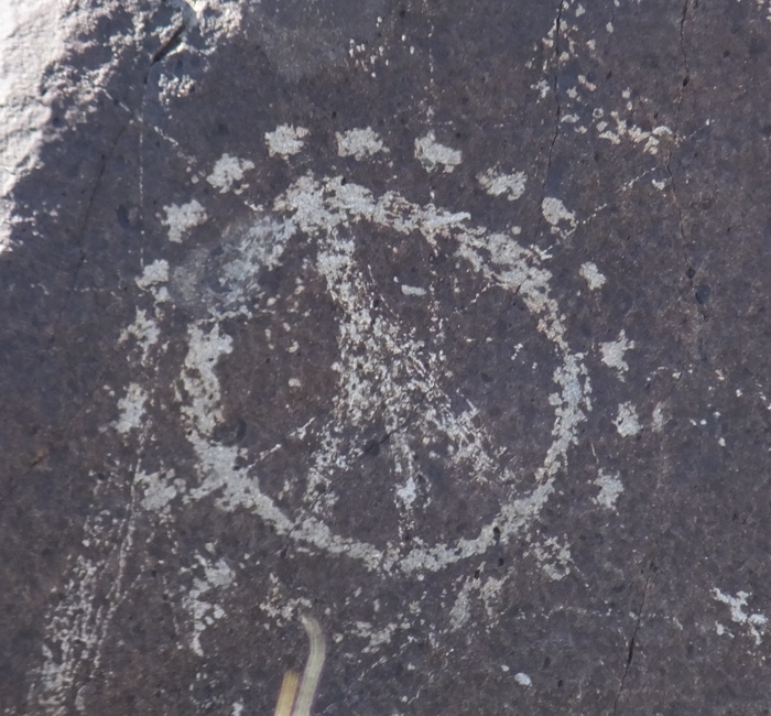 Petroglyph of peace symbol with dots around it