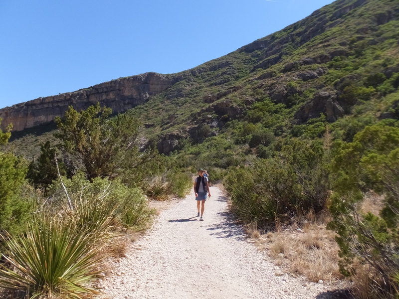 Carmen walking on a gravelly trail