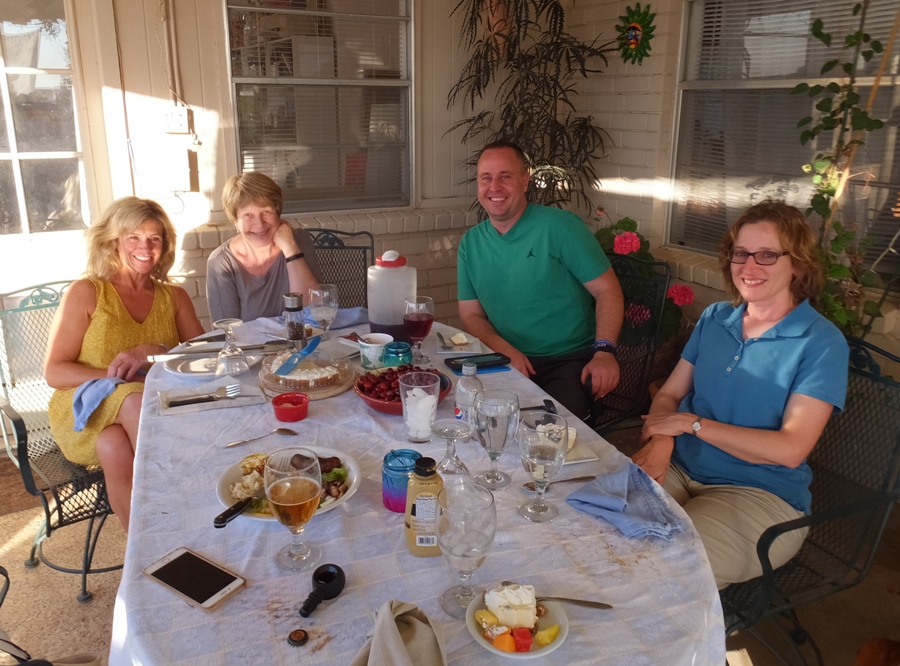 Group photo around table outside