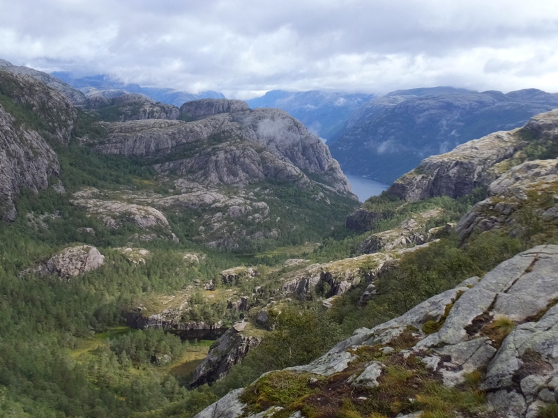 Lots of rocks with a fjord in the distance