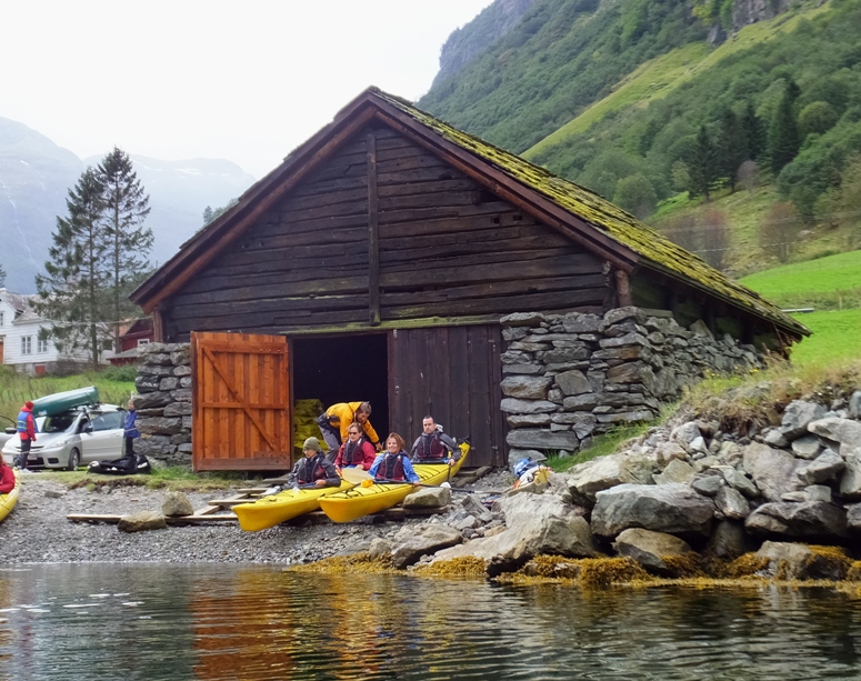 Carmen and Norma in a tandem kayak on the shore with another couple