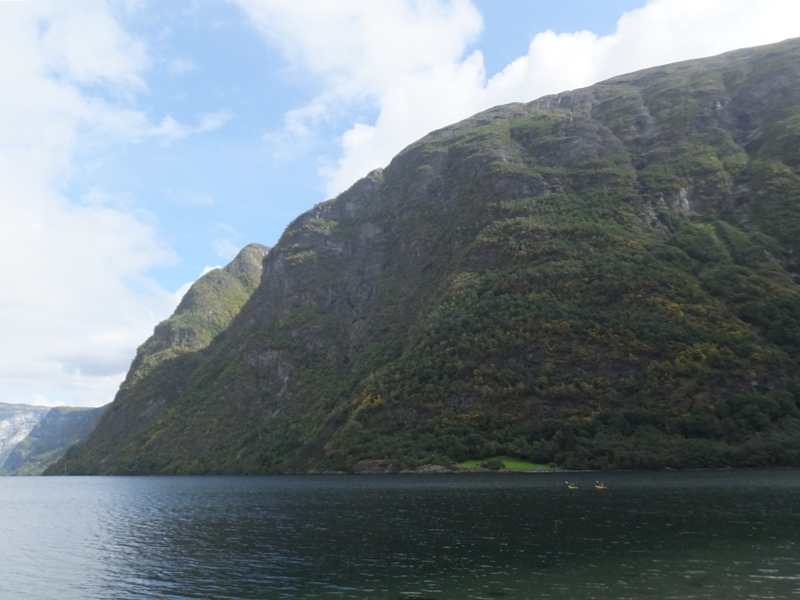 Big mountains with kayakers from another group down below.