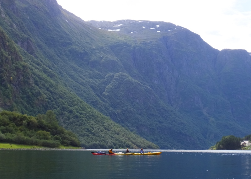 Two kayaks with big mountains in the background