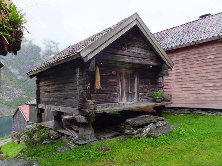 Wooden house built on risers shaped like mushrooms