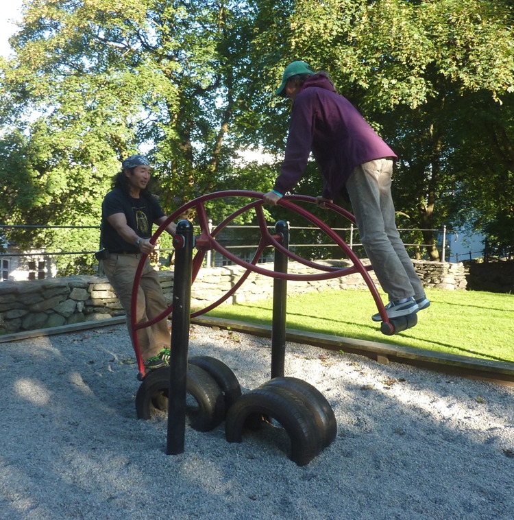 Carmen and I on a see-saw-like piece of playground equipment