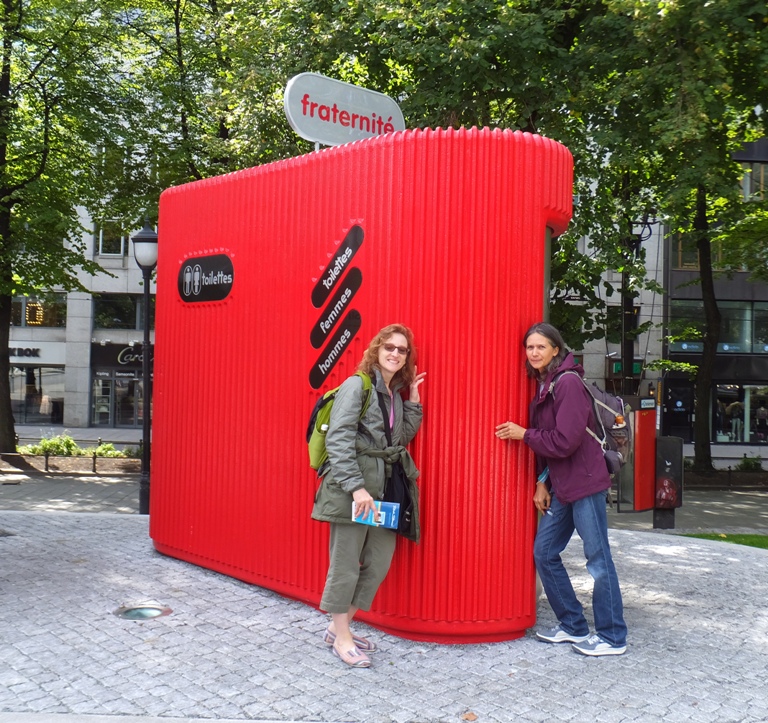 Norma and Carmen in front of public toilet