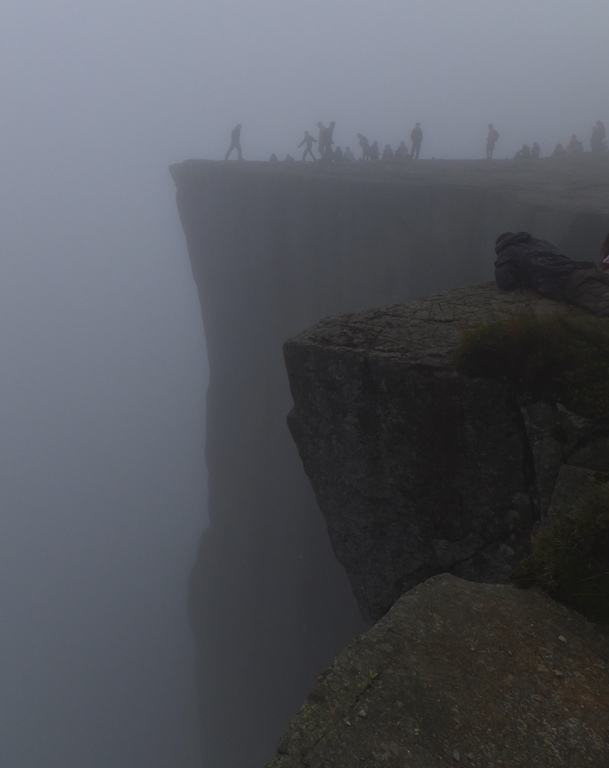 The outline of people on Pulpit Rock in the fog