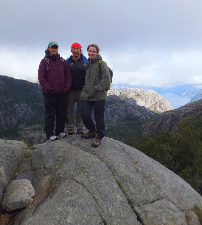 The three of us on a rock with landscape scenery behind