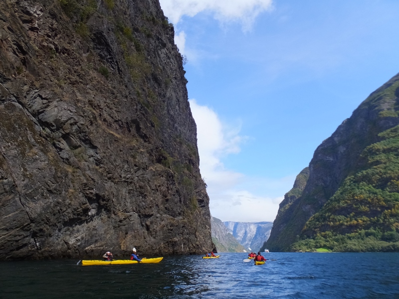 Kayakers next to steep cliff