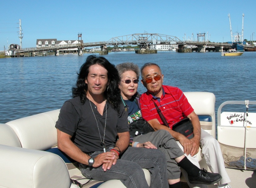 Mom, Dad, and I on Spider's boat with me squinting at the sun