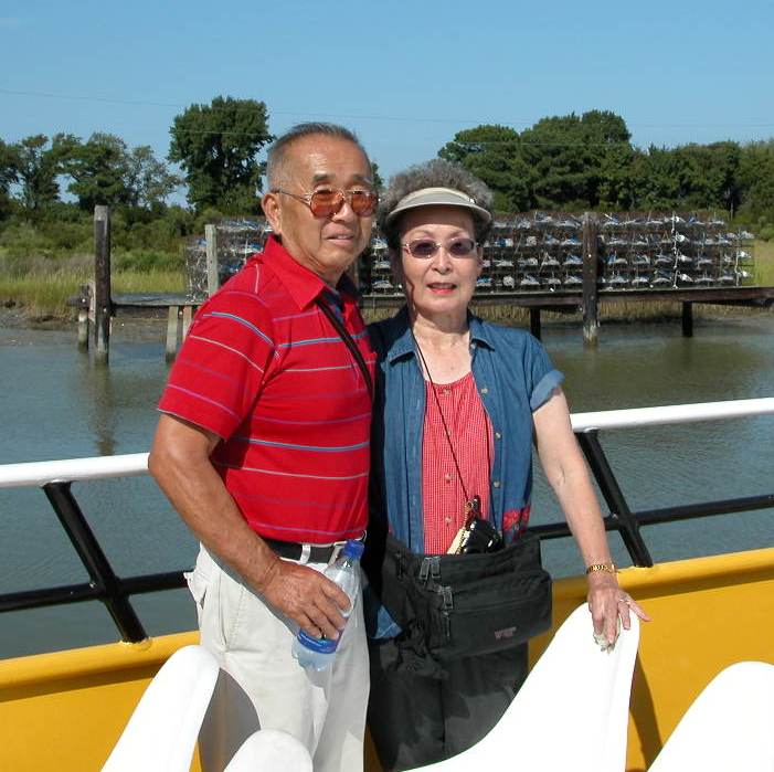 Dad and Mom on the tour boat with crab pots behind