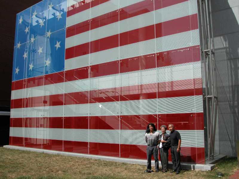 My folks and I in front of giant U.S. flag