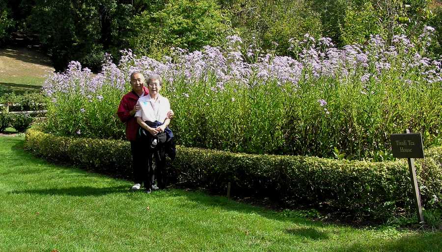 My parents in front of well-groomed section of the gardens