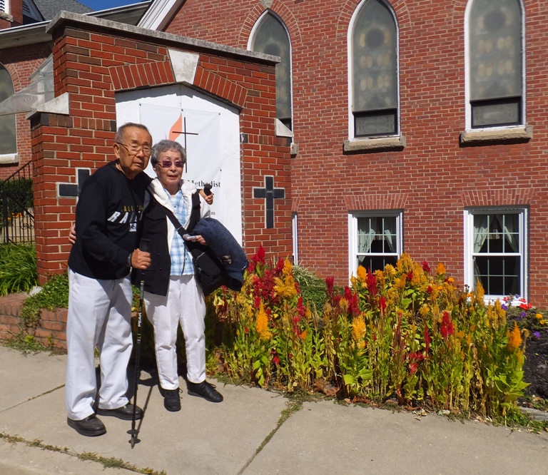 Mom and Dad in front of Methodist Church and celosia flowers